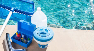 A pool cleaning kit next to a swimming pool